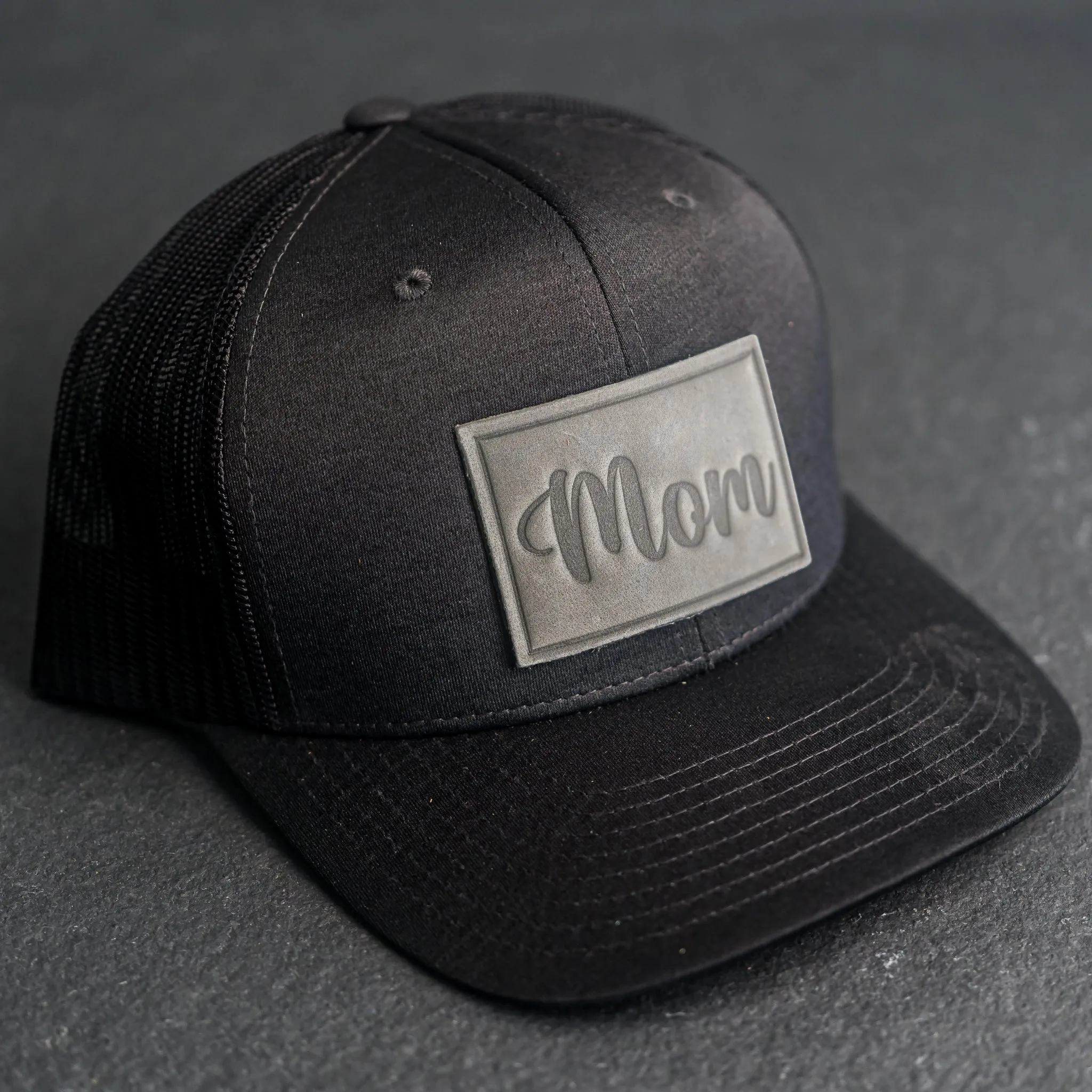 Leather Patch Performance Style Trucker Hat - Mom Cursive Stamp