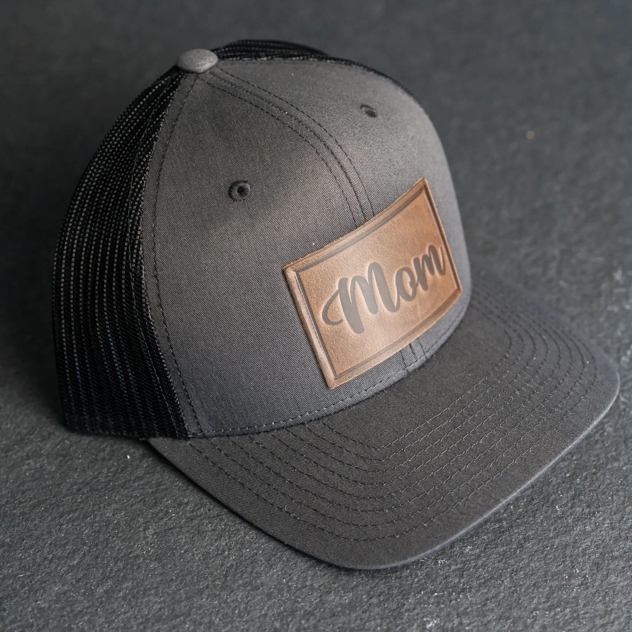 Leather Patch Trucker Style Hat - Mom Cursive Stamp